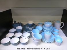 Two Poole pottery tea sets with milk jugs,