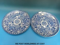 A pair of late 19thC / early 20thC Chinese blue and white chargers decorated with dragons and