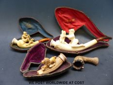A cased Meerschaum type pipe carved in the form of a girl with a dog together with two cased