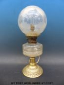 A brass oil lamp converted to electricity with chrysanthemums etched to glass shade