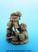 A Japanese Meiji period carved ivory netsuke of a puppeteer and a musician (4.