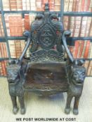 A late 19thC carved hardwood figural throne chair with carved lion arm rests and legs,