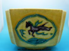 An early Chinese square dish with green and aubergine coloured decoration depicting a horse and