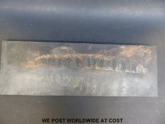 WWI interest carved slate panel depicting soldiers moving at night with shell fire beyond,