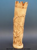 A 19thC African ivory tusk carved with stylized figures of men hunting an ostrich (31cm tall)