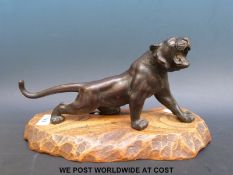 A Japanese Meiji period bronze tiger on elm base