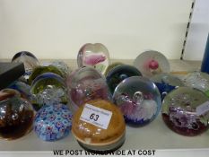 A large collection of glass paperweights including Caithness 2002, Raindrop, Totnes, Selkirk,