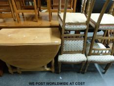 A light oak drop leaf table (H75 x L160 x W110cm) and four upholstered oak chairs