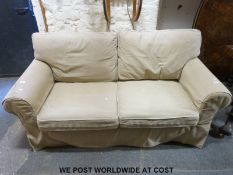 A beige three seat sofa (L174cm)
