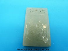 A rectangular jadeite pendant with carved calligraphy to one side and carved lily pads to the other