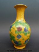 A Chinese vase with yellow ground and blue and purple flower (15cm tall)