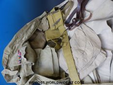 A collection of desert khaki uniforms to include shirt, trousers,
