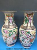A pair of 19thC Chinese crackle glazed vases with enamelled figural decoration and seal marks to