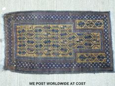 A small Turkoman rug with a central panel of floral design on a beige ground (150 x 85cm)