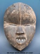 An African tribal Dan mask with metal teeth and sectioned forehead (length 26cm)