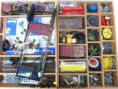 A collection of Meccano parts and components in two fitted wooden trays