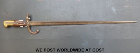A c1879 French bayonet with the narrow 'T' form blade, wood grips and brass pommel.