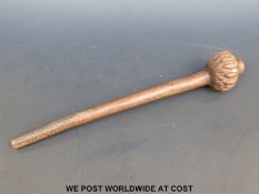 A carved hardwood knobkerrie with inset tooth (32.