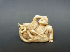 A Japanese Meiji period signed carved ivory netsuke of a figure with a club and a horned figure (3.