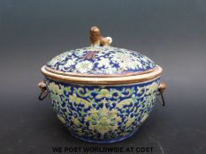A Chinese famille rose covered bowl with foo dog finial and handles (12.