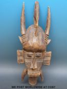 An African tribal mask with a bird to the top, Senufo tribe,