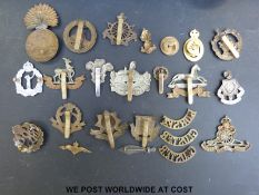 A collection of military badges, figural cigar cutter, candle and match holder,