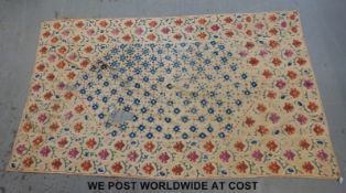 An 18thC Suzani embroidered panel /throw featuring hand finished decoration of foliage on a cream