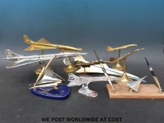 A collection of models of Concorde including desk stands, brass examples, silver dreams,