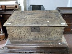 An antique carved oak bible box (H25 x L65 x W43cm)