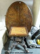 A 19thC burr walnut oval breakfast table supported by four turned columns,