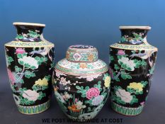 A pair of Chinese famille noir vases (30cm tall) and a ginger jar (23cm tall)