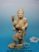 A Japanese Meiji period signed carved okimono of a fruit or gourd gatherer with an axe (12cm tall)