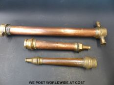 Two fire service type nozzles and a further copper and brass pipe