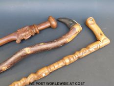 Three tribal walking sticks including a Maori example (largest 94cm long)