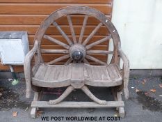 A wheel back rustic bench (H125cm x W120cm x D78cm)