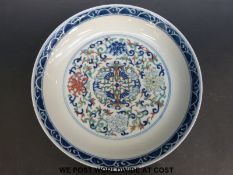 A Chinese dish decorated with blue, green and red,