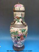 A large 19thC crackle glaze Chinese lidded vase with dragons in relief and foo dog finial with