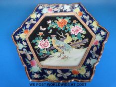 A Chinese famille noir hexagonal charger decorated with birds (32cm diameter)