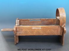 A 19thC carved African hardwood travelling cot with all over carved geometric decoration (H42 x L80