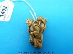 A signed Japanese Meiji period carved ivory netsuke of a woman with an octopus on her back (4.