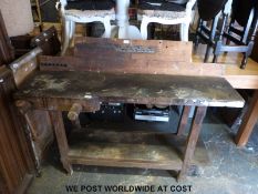 A pine workbench with integral vice,