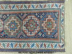 A Turkoman runner with seven large guls and geometric borders (285 x 105cm)