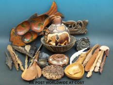 A collection of carved African artefacts to include a gourd, a bowl, spoons,