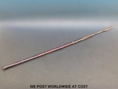 An 18th / 19thC African short spear with hide grip and chased metal mounts (length 94cm)
