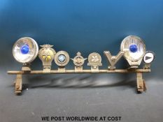 A chrome car bumper bar mounted with various RAC,