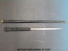 A swordstick with heavily carved wooden handle,