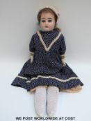 Armand Marseille bisque headed doll with open mouth, fixed blue eyes, brown hair,