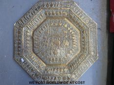 An Indian brass octagonal tabletop repoussé decorated with a processional scene and elephants to