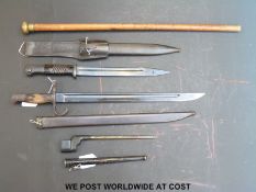 Three WWII era bayonets including German and Japanese together with a swagger stick