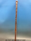 A Chinese bamboo walking cane with carved monkeys,